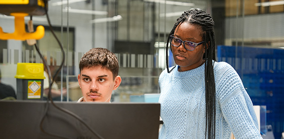 Students looking at some work on a computer