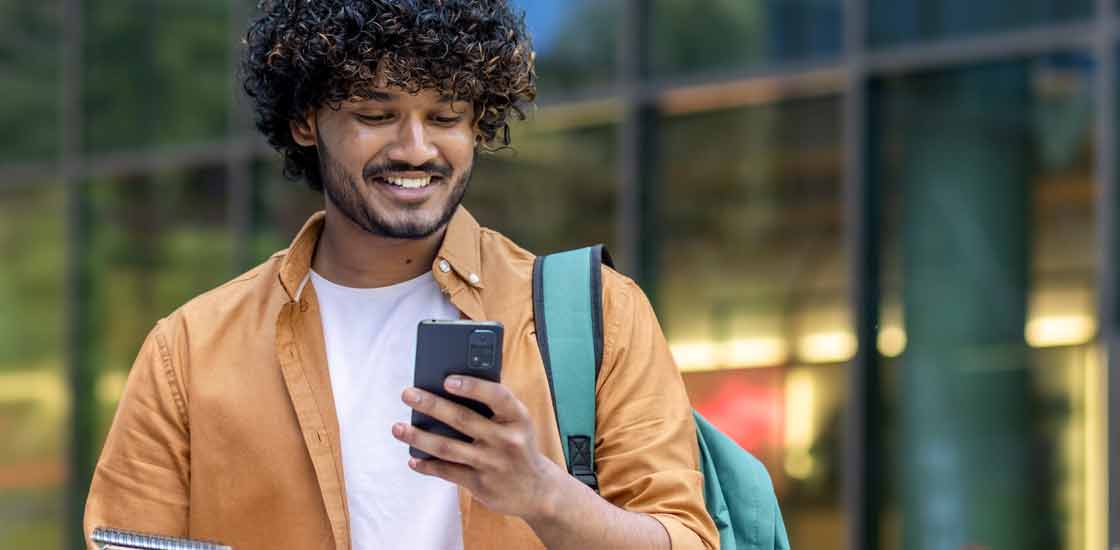 Male looking at phone and smiling