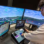 Student operating a flight simulator